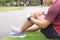 Knee Injuries. Young sport man holding knee with his hands in pain after suffering muscle injury during a running workout at park