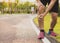 Knee Injuries. Young sport man holding knee with his hands in pain after suffering muscle injury during a running workout at park