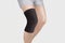 Knee Support Brace on leg isolated on white background. Orthopedic Anatomic Orthosis. Braces for knee fixation, injuries and pain.