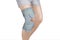 Knee Support Brace on leg isolated on white background. Orthopedic Anatomic Orthosis. Braces for knee fixation, injuries and pain.