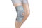 Knee Support Brace on leg isolated on white background. Orthopedic Anatomic Orthosis. Braces for knee fixation, injuries and pain.