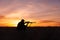 Kneeling Rifle Hunter Shooting in Sunset