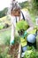 Kneeling woman gardening with gloves