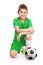 Kneeling young soccer player with football