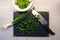 Knife and black cutting board filled with green onions cutted as meal preparations