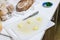 Knife board with chopped garlic, home kitchen cooking with bread background