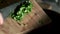 Knife into bowl chopped parsley on wooden board. Salad preparation