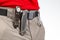 knife, carabiner and flashlight with clips on the waistband of trekking trousers. EDC items