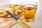 Knife on charlotte in mold on napkin, cup with tea on wooden table