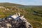 Knife, compass, map and deer horn on the rock