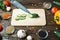 Knife, cucumbers paprika tomatoes and garlic lie on a wooden background