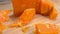 Knife cuts and breaks a delicious hard french orange-colored Mimolette cheese