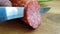 The knife cuts salami sausage ingredient homemade gourmet