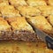 Knife cutting baklava, traditional middle east sweet desert