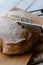 Knife cutting a loaf of homemade no-knead bread