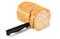 Knife cutting whole grain bread