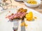 knife with fork and gnawed bone on plate