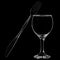 Knife and fork leaning on wine glass