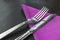 Knife and fork with violet napkin