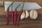 Knife, garlics and chillies on chopping board