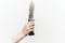 knife in hand close-up light background edged weapon
