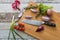 Knife with healthy food - vegetables, onion, salad, tomatoes, potato placed on a cutting board with wood background top view