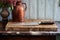 a knife lodged in a wooden chopping board on a marble kitchen counter