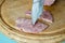 The knife pierces a piece of Homemade chopped ham with garlic, s