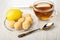 Knife, saucer with lemon, creamy fudge, transparent cup with tea, spoon on wooden table