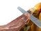 Knife slicing jamon or parma ham isolated