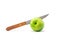 Knife stab in green apple isolated