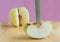 Knife stabbed into chinese pear on the wooden board