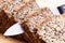 Knife in wholemeal, wholewheat bread on wooden table. Organic, healthy food