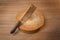 Knife on a wooden butcher on wooden background.