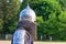 Knight in combat armor close up in profile_