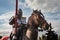 Knight on horseback. Horse in armor with knight holding lance. Horses on the medieval battlefield.