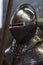 Knight in metal armor and helmet with closed visor before the fight, selective focus.