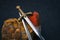 Knight`s sword against a background of red and brown stones