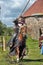 A knight with a spear on a horse at the Russian Fortress festival of historical reconstruction