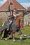 A knight with a spear on a horse at the Russian Fortress festival of historical reconstruction