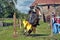 A knight with a spear on a horse at the Russian Fortress festival of historical reconstruction