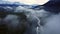 Knik River flowing through valley surrounded by snowy Pioneer Peak mountains in Alaska