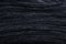 Knit dark blue fabric texture, background or backdrop. Textile, scarf or sweater textured surface. Warm accessories, clothing