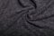 Knit grey fabric texture, background or backdrop. Textile, scarf or sweater textured surface. Warm accessories, clothing