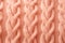 Knitted background in peach fuzz