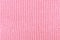 Knitted background of pink color.Abstract fabric texture, top view.Closeup.Detailed textile warm surface.Natural woolen pattern of