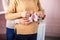 Knitted booties in the hands of a pregnant woman next to her husband. waiting for a miracle