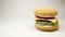 Knitted burger falls in a left side on a white background, Close Up