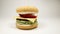 Knitted burger falls on a white background, Close Up