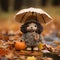 a knitted doll holding an umbrella and a pumpkin